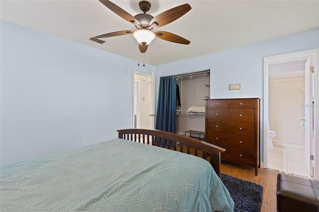 1723 Needle Palm Dr, Edgewater, FL 32132 - bedroom with wood finished floors, a closet, ceiling fan, and ensuite bathroom