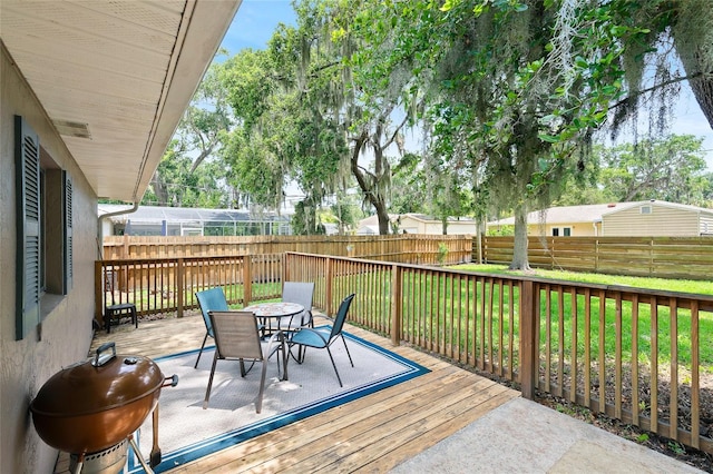 1723 Needle Palm Dr, Edgewater, FL 32132 - deck featuring outdoor dining space, a fenced backyard, and a grill