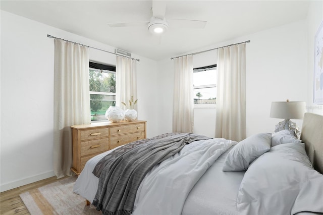 25 Dolphin Ave, Ormond Beach, FL 32176 - bedroom with light wood finished floors, baseboards, and ceiling fan