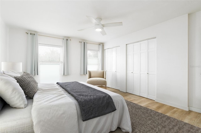 25 Dolphin Ave, Ormond Beach, FL 32176 - bedroom featuring multiple closets, light wood-style flooring, and a ceiling fan