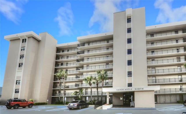 4435 S Atlantic Ave Unit 416, Port Orange, FL 32127 - view of apartment building / complex featuring uncovered parking