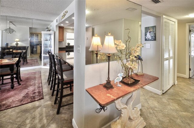 4435 S Atlantic Ave Unit 416, Port Orange, FL 32127 - dining area with a textured ceiling, tile patterned flooring, and baseboards