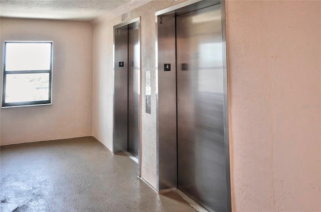4435 S Atlantic Ave Unit 416, Port Orange, FL 32127 - hallway with elevator and concrete floors