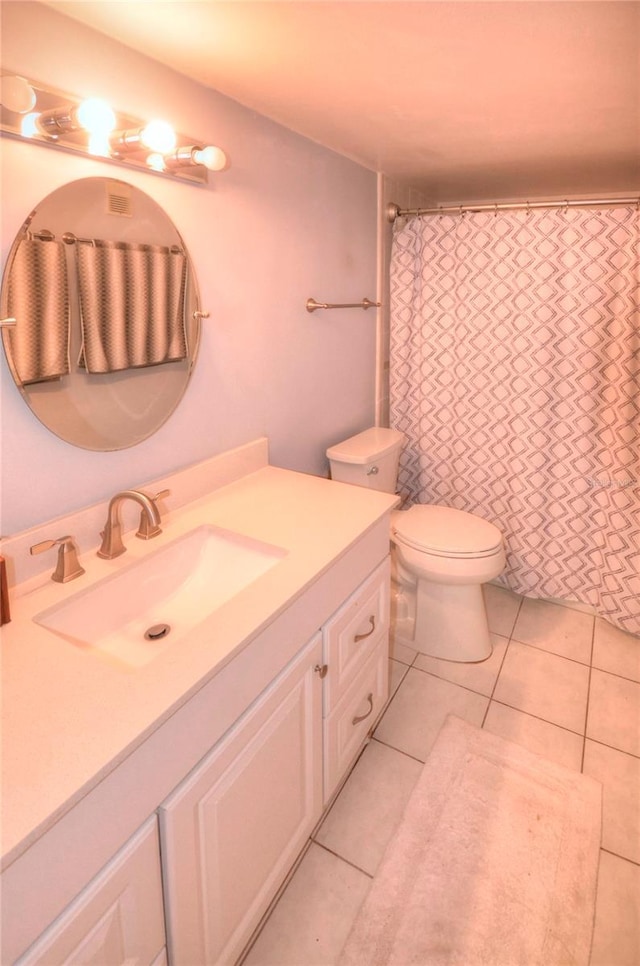 4435 S Atlantic Ave Unit 416, Port Orange, FL 32127 - full bath with vanity, toilet, tile patterned floors, and a shower with shower curtain