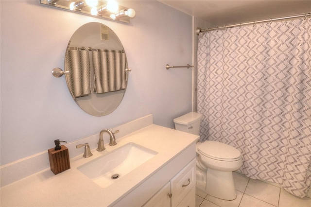 4435 S Atlantic Ave Unit 416, Port Orange, FL 32127 - bathroom with vanity, toilet, and tile patterned flooring