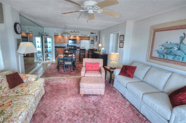 4435 S Atlantic Ave Unit 416, Port Orange, FL 32127 - living room with ceiling fan and a textured ceiling