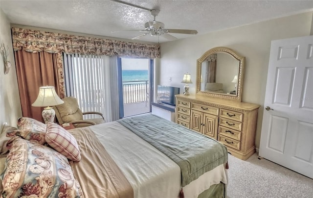 4435 S Atlantic Ave Unit 416, Port Orange, FL 32127 - bedroom with access to exterior, light colored carpet, a textured ceiling, and a ceiling fan