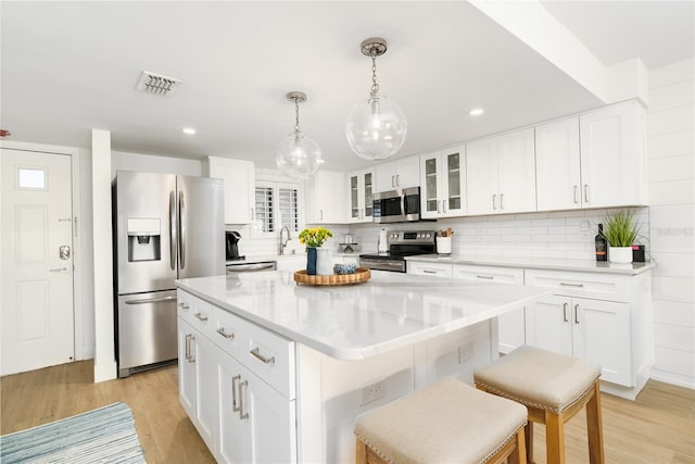 5501 S Atlantic Ave Unit 4090, New Smyrna Beach, FL 32169 - kitchen with appliances with stainless steel finishes, light wood finished floors, a center island, tasteful backsplash, and recessed lighting