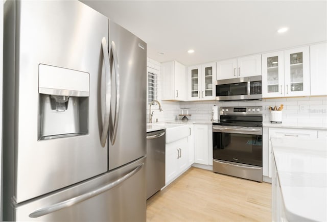 5501 S Atlantic Ave Unit 4090, New Smyrna Beach, FL 32169 - kitchen with appliances with stainless steel finishes, decorative backsplash, light countertops, white cabinets, and recessed lighting