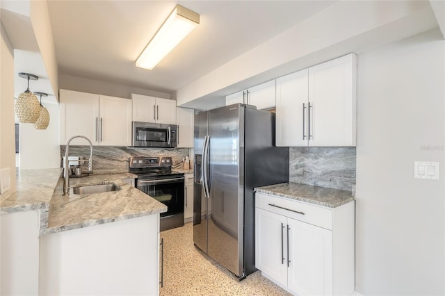 2900 S Peninsula Dr, Daytona Beach, FL 32118 - kitchen featuring stainless steel appliances, a sink, white cabinetry, and tasteful backsplash