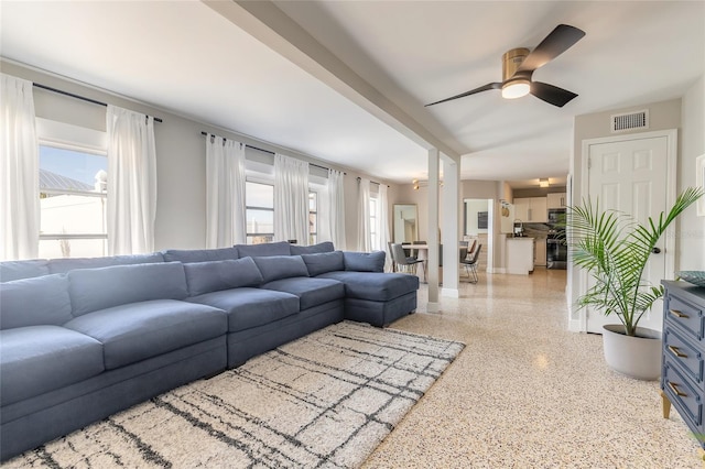 2900 S Peninsula Dr, Daytona Beach, FL 32118 - living area with dark aggregate flooring, ceiling fan, and baseboards