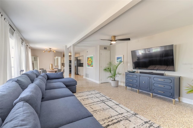 2900 S Peninsula Dr, Daytona Beach, FL 32118 - living room featuring dark aggregate flooring, a chandelier, baseboards, and a ceiling fan