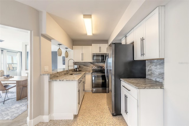 2900 S Peninsula Dr, Daytona Beach, FL 32118 - kitchen featuring stainless steel appliances, a sink, white cabinets, backsplash, and light stone countertops