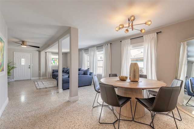 2900 S Peninsula Dr, Daytona Beach, FL 32118 - dining space with dark speckled floor, a chandelier, baseboards, and ceiling fan