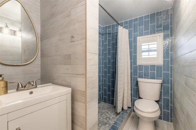 2900 S Peninsula Dr, Daytona Beach, FL 32118 - full bathroom with tile walls, toilet, vanity, and tiled shower