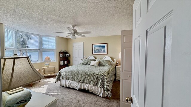 2700 N Peninsula Ave Unit 322, New Smyrna Beach, FL 32169 - carpeted bedroom featuring a textured ceiling and a ceiling fan