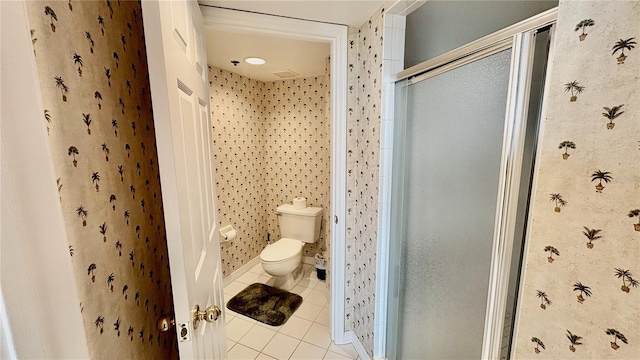 2700 N Peninsula Ave Unit 322, New Smyrna Beach, FL 32169 - bathroom featuring tile patterned floors, a shower stall, and toilet