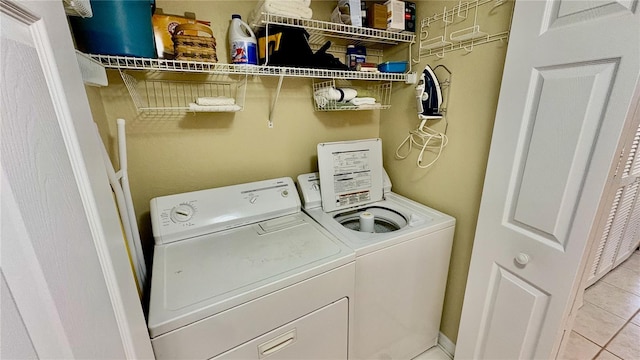 2700 N Peninsula Ave Unit 322, New Smyrna Beach, FL 32169 - washroom featuring independent washer and dryer and light tile patterned flooring
