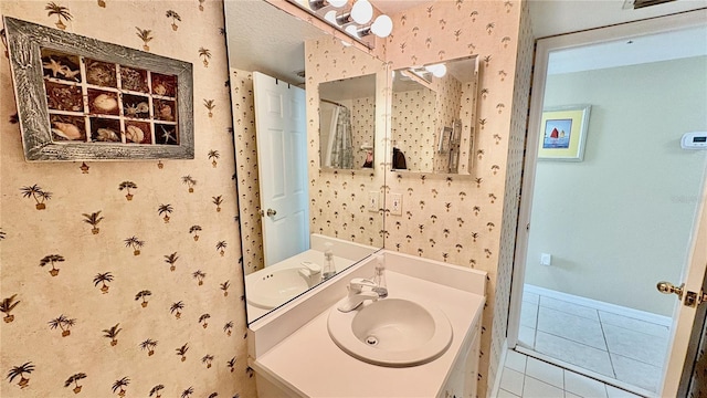 2700 N Peninsula Ave Unit 322, New Smyrna Beach, FL 32169 - bathroom with wallpapered walls, tile patterned floors, vanity, and baseboards