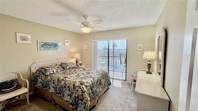 2700 N Peninsula Ave Unit 322, New Smyrna Beach, FL 32169 - carpeted bedroom with access to exterior, a textured ceiling, and ceiling fan