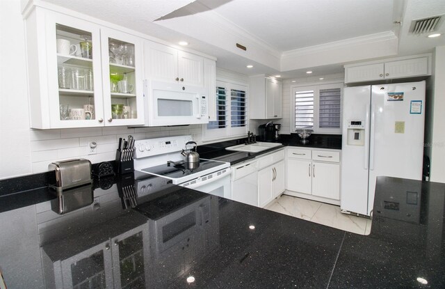 5301 S Atlantic Ave Unit 140, New Smyrna Beach, FL 32169 - kitchen featuring white appliances, a sink, ornamental molding, a tray ceiling, and light marble finish floors