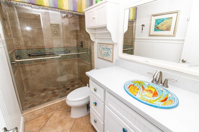 5301 S Atlantic Ave Unit 140, New Smyrna Beach, FL 32169 - full bathroom with vanity, a stall shower, toilet, and tile patterned floors