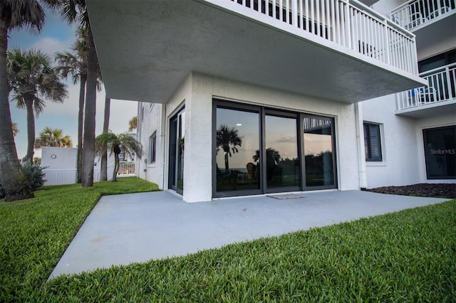 5301 S Atlantic Ave Unit 140, New Smyrna Beach, FL 32169 - back of house with a patio, stucco siding, and a yard
