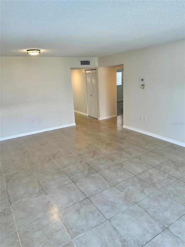 315 N Causeway Unit 2060, New Smyrna Beach, FL 32169 - unfurnished room featuring a textured ceiling and baseboards