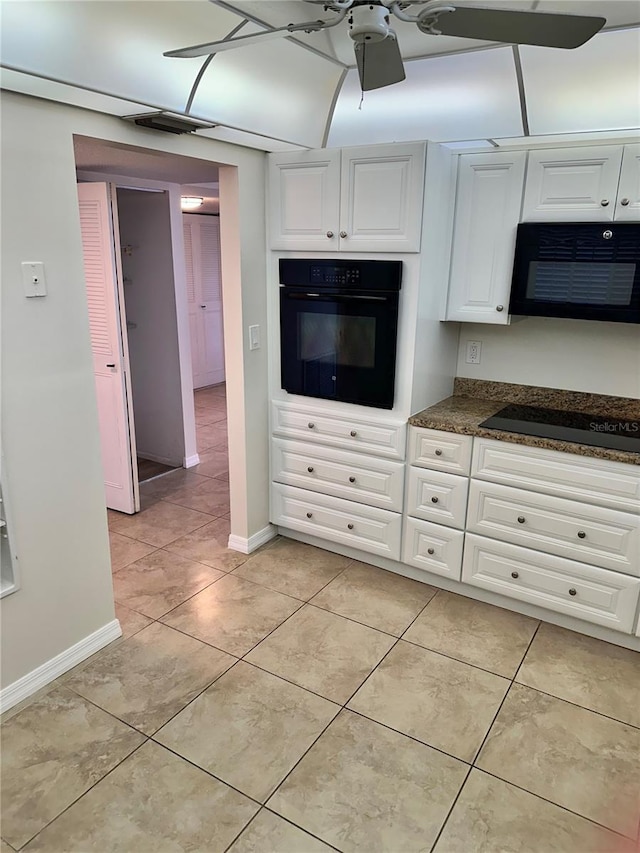 315 N Causeway Unit 2060, New Smyrna Beach, FL 32169 - kitchen featuring black appliances, white cabinetry, dark countertops, and baseboards
