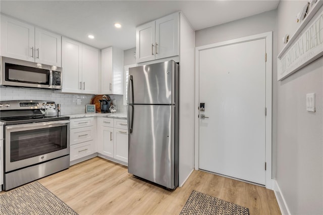 4151 S Atlantic Ave Unit 3090, New Smyrna Beach, FL 32169 - kitchen featuring stainless steel appliances, light countertops, white cabinets, decorative backsplash, and recessed lighting