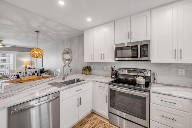 4151 S Atlantic Ave Unit 3090, New Smyrna Beach, FL 32169 - kitchen featuring stainless steel appliances, a sink, a peninsula, decorative backsplash, and recessed lighting