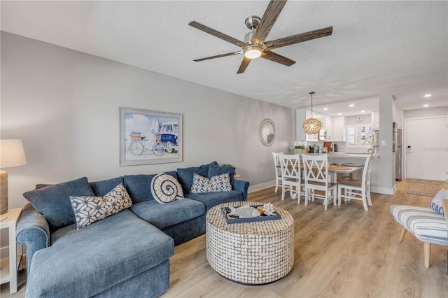 4151 S Atlantic Ave Unit 3090, New Smyrna Beach, FL 32169 - living area with ceiling fan, light wood finished floors, a textured ceiling, baseboards, and recessed lighting