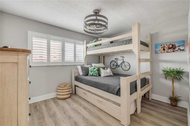 4151 S Atlantic Ave Unit 3090, New Smyrna Beach, FL 32169 - bedroom with wood finished floors, a textured ceiling, and baseboards