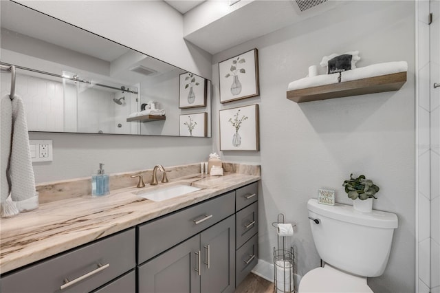 4151 S Atlantic Ave Unit 3090, New Smyrna Beach, FL 32169 - full bathroom with vanity, toilet, a shower, and wood finished floors
