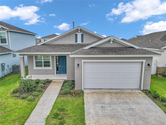 7223 SW 61st Pl, Ocala, FL 34474 - view of front of home with a shingled roof, an attached garage, concrete driveway, covered porch, and stucco siding
