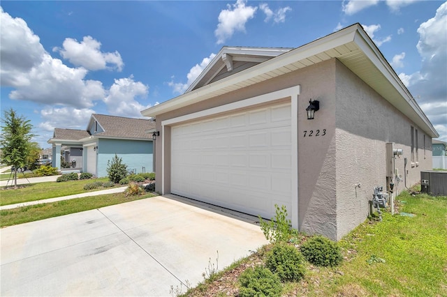 7223 SW 61st Pl, Ocala, FL 34474 - view of property exterior featuring stucco siding, concrete driveway, and a garage