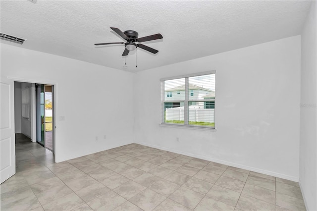 7223 SW 61st Pl, Ocala, FL 34474 - unfurnished room with a textured ceiling, a ceiling fan, and light tile patterned floors