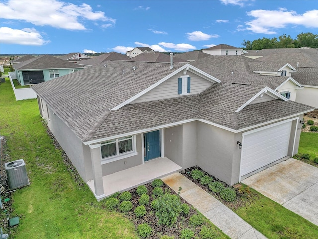 7223 SW 61st Pl, Ocala, FL 34474 - view of front of home with a shingled roof, an attached garage, a residential view, and stucco siding