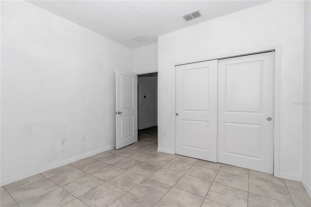 7223 SW 61st Pl, Ocala, FL 34474 - unfurnished bedroom featuring light tile patterned floors and a closet