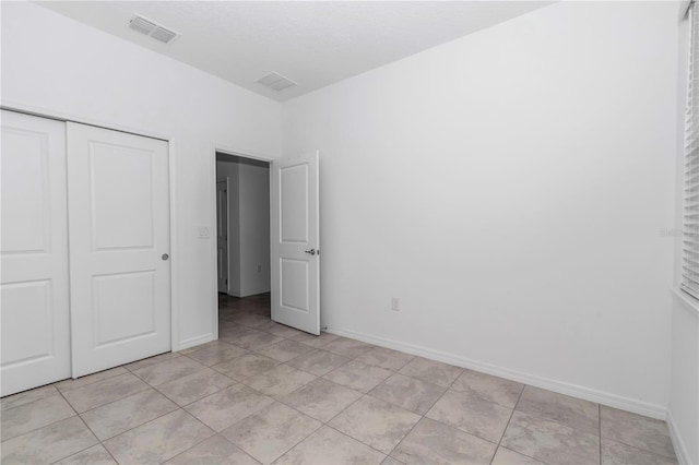 7223 SW 61st Pl, Ocala, FL 34474 - unfurnished bedroom with a closet and light tile patterned flooring