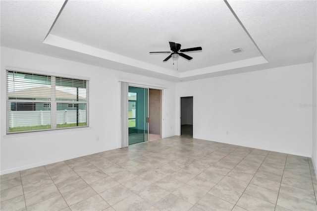 7223 SW 61st Pl, Ocala, FL 34474 - empty room featuring a raised ceiling, ceiling fan, and a textured ceiling