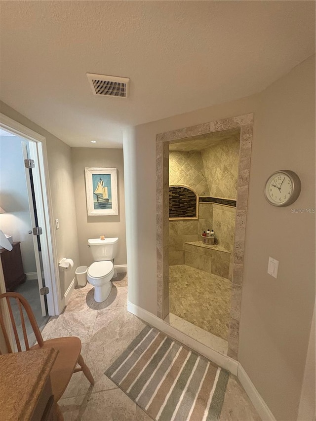 38 Cedar Dunes Dr, New Smyrna Beach, FL 32169 - bathroom with a walk in shower, baseboards, toilet, and a textured ceiling