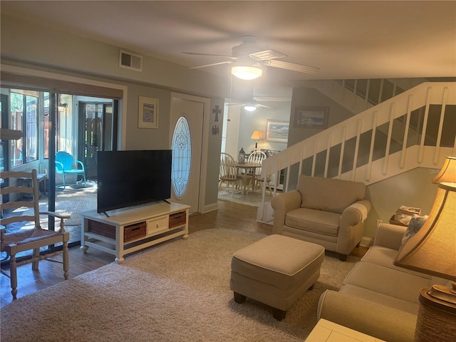 38 Cedar Dunes Dr, New Smyrna Beach, FL 32169 - living area featuring ceiling fan, stairs, and wood finished floors
