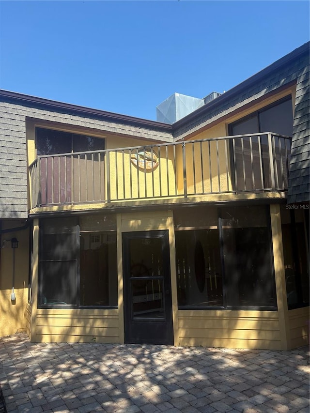 38 Cedar Dunes Dr, New Smyrna Beach, FL 32169 - back of property with a balcony and a patio