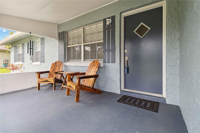 1920 Travelers Palm Dr, Edgewater, FL 32141 - doorway to property with covered porch and stucco siding