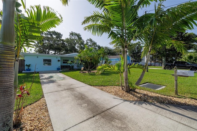 653 Goodwin Ave, New Smyrna Beach, FL 32169 - view of front of house with driveway and a front lawn