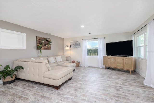 653 Goodwin Ave, New Smyrna Beach, FL 32169 - living area featuring light wood finished floors, healthy amount of natural light, and baseboards