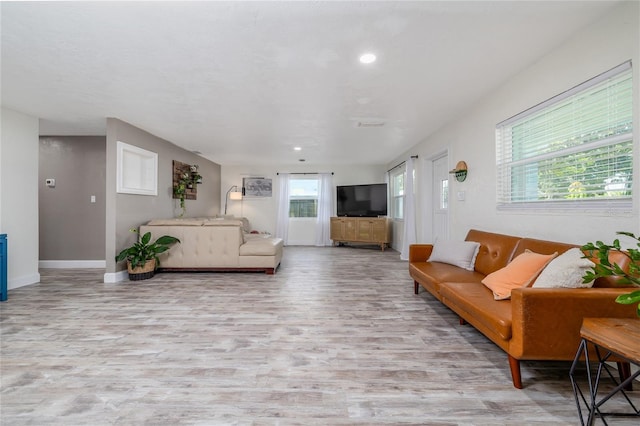 653 Goodwin Ave, New Smyrna Beach, FL 32169 - living room with wood finished floors, baseboards, and recessed lighting