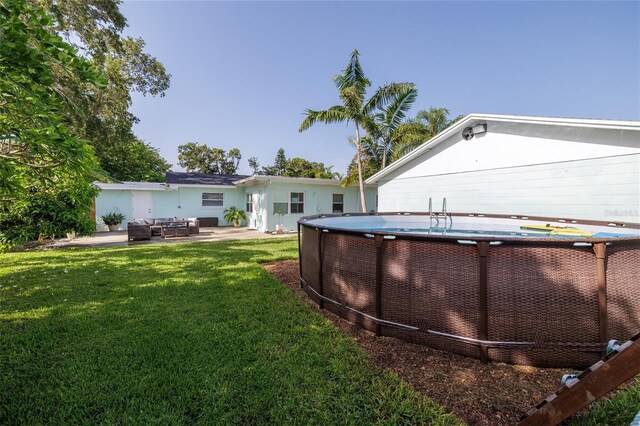 653 Goodwin Ave, New Smyrna Beach, FL 32169 - view of grassy yard featuring an outdoor hangout area and a patio area