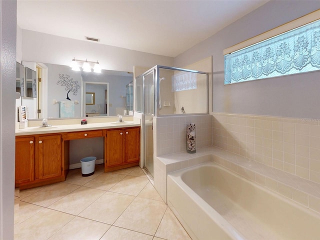 686 Middlebury Loop, New Smyrna Beach, FL 32168 - bathroom featuring a garden tub, tile patterned flooring, double vanity, and a stall shower